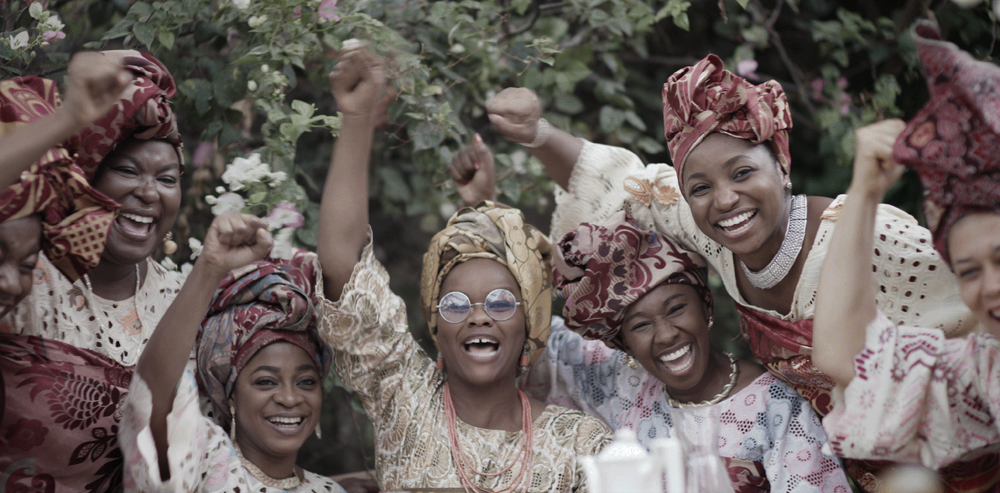 Pictured: Funmilayo Ransome‑Kuti centered among a posed group of the 1946 Abeokuta Women’s Union members, all wearing traditional Yoruba dress.