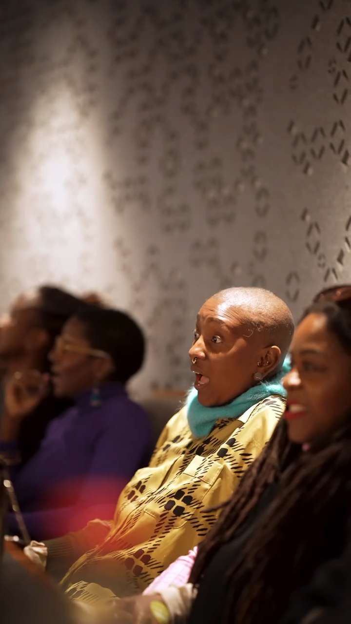 Close‑up of an audience member with wide eyes and parted lips, absorbed by the film’s opening scene.